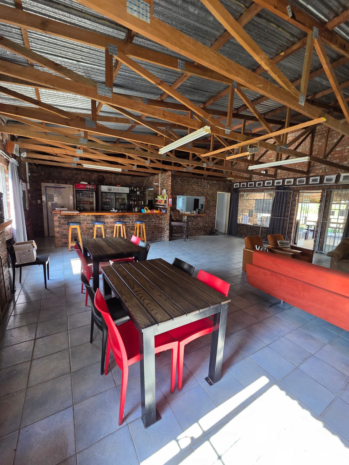 The bar and dining tables inside the PECTC clubhouse under exposed timber trusses
