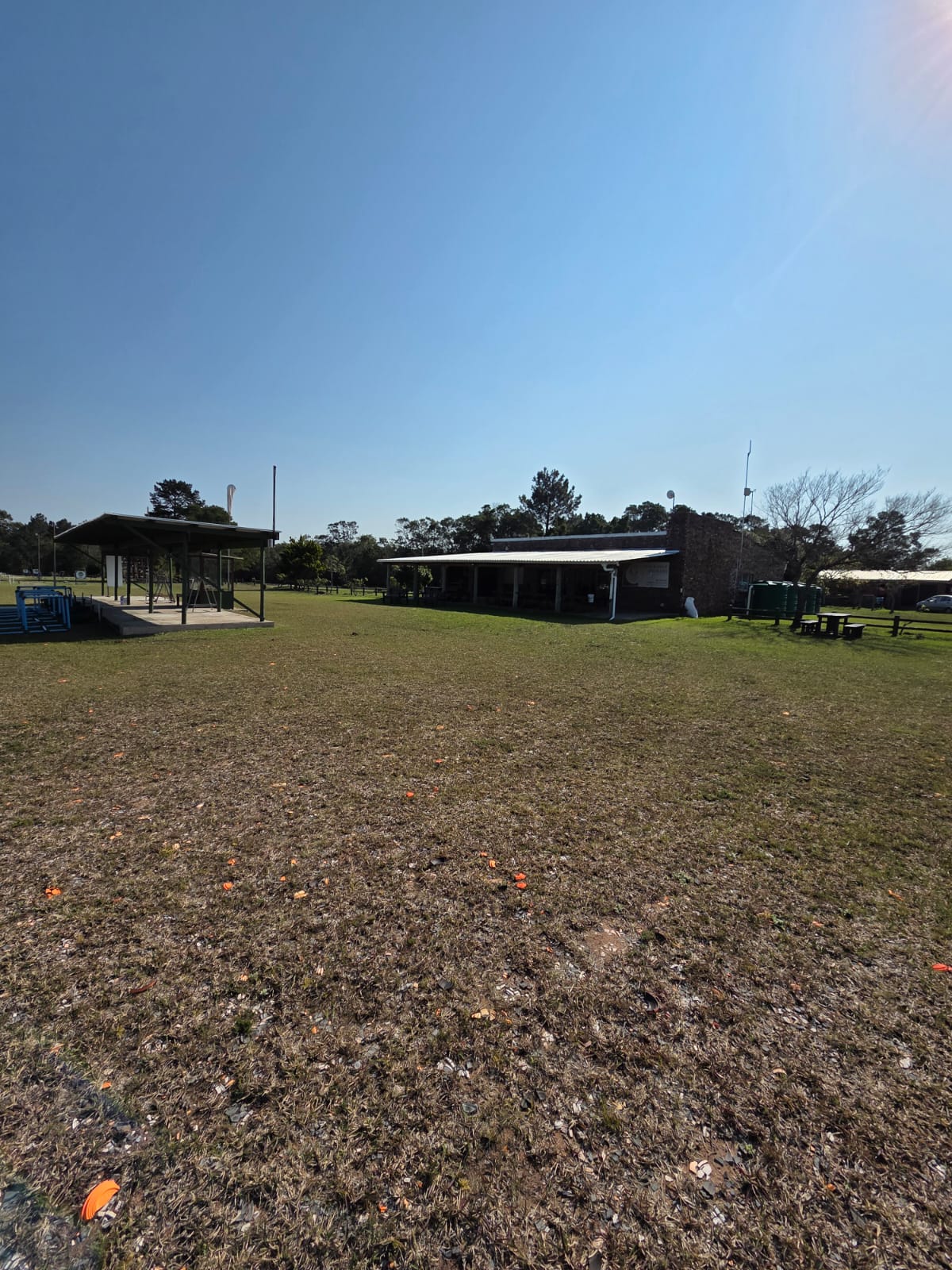 The PECTC grounds with the clubhouse and a covered shooting stand across the grass