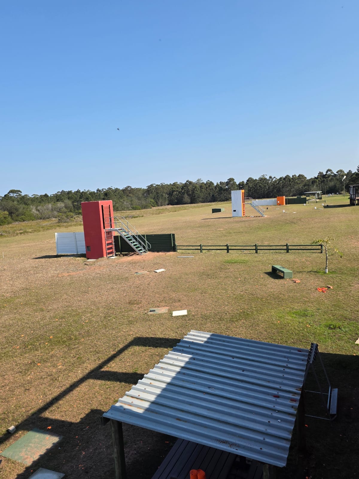 Trap and sporting target towers spread across the grass ranges at PECTC