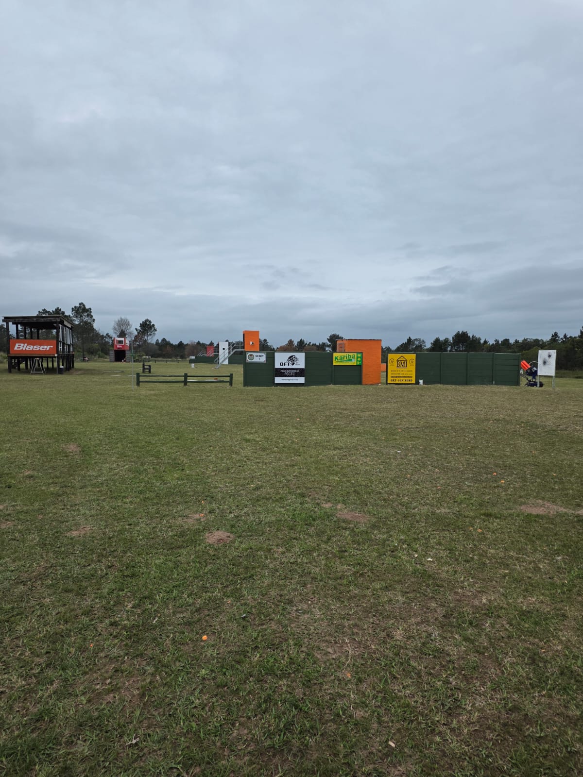 The PECTC sporting ground with the Blaser stand, sponsor boards and orange target towers across the grass