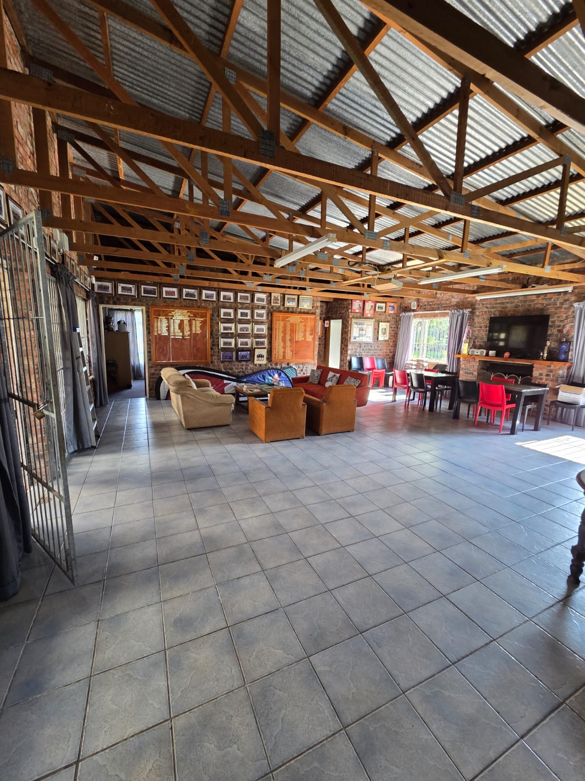 The PECTC clubhouse lounge with honours boards, framed team photographs and couches